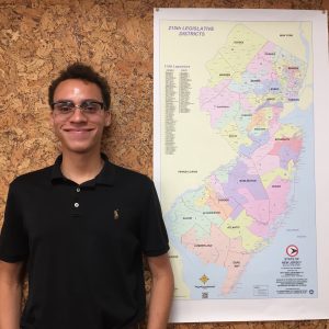 Miles Franklin standing next to map of New Jersey