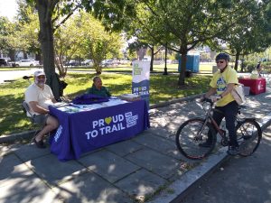 Ciclovia booth with people talking