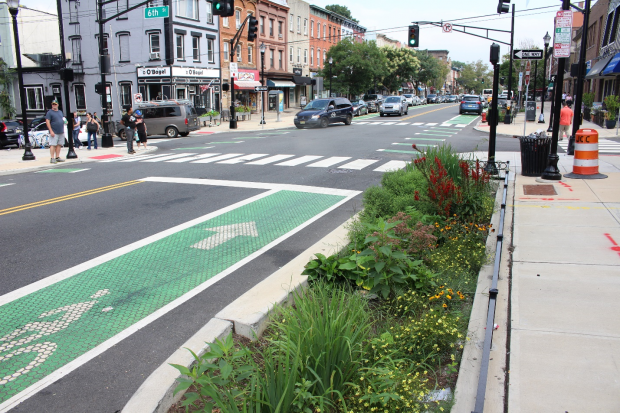 Photo of Washington Street in Hoboken with bike lane, walk ways, green infrastructure, and pedestrians. 